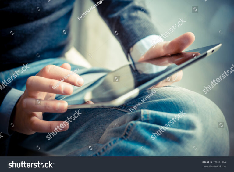 stock-photo-close-up-hands-multitasking-man-using-tablet-laptop-and-cellphone-connecting-wifi-173451509